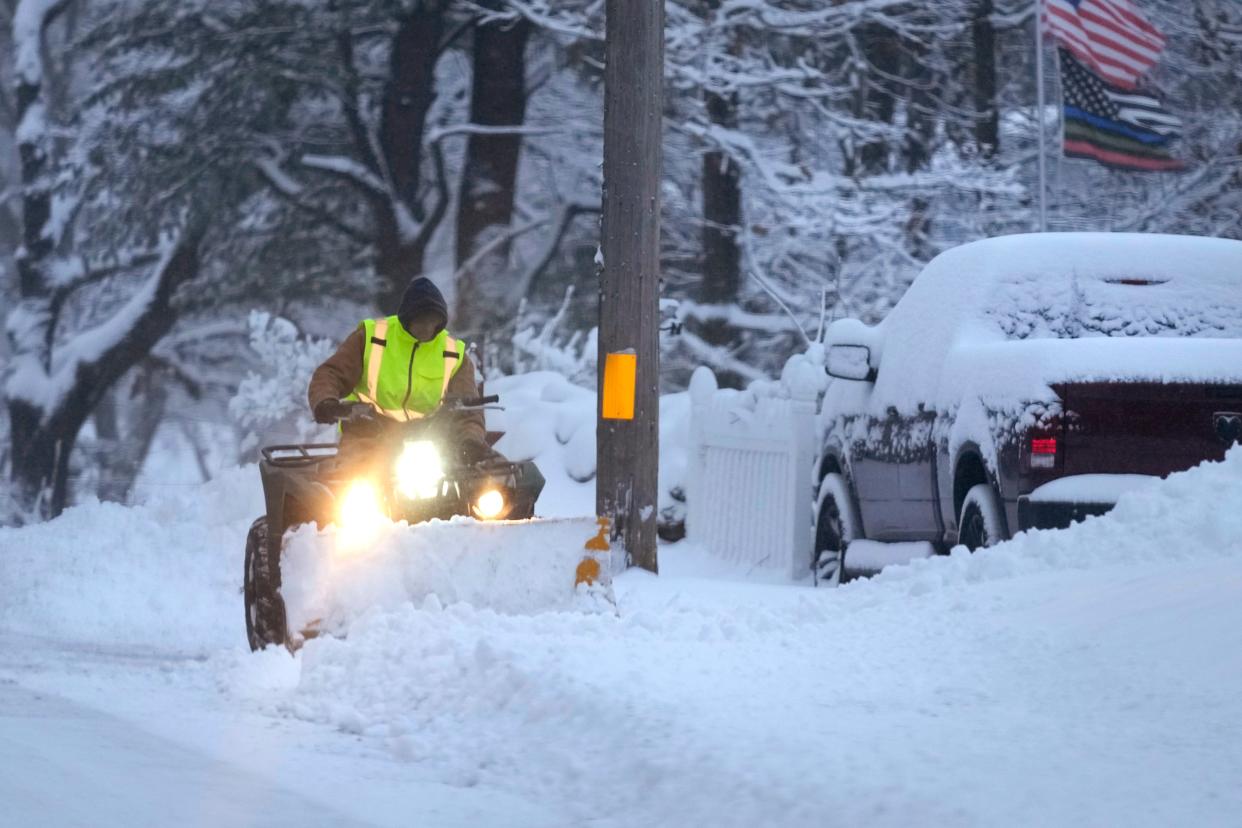 A man plows a snow-covered driveway on 7 January in Derry, New Hampshire (Copyright 2024 The Associated Press. All rights reserved)