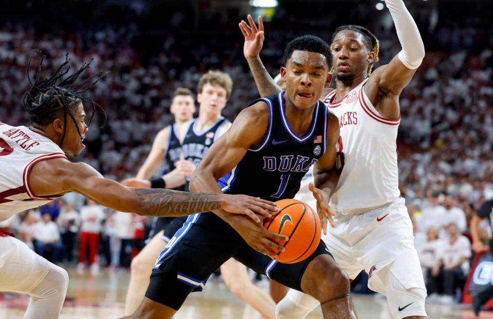 Arkansas’ Khalif Battle (0), left, and El Ellis (3) defend Duke’s Caleb Foster (1) during the second half of Arkansas’ 80-75 victory over Duke at Bud Walton Arena in Fayetteville, Ark., Weds. Nov. 29, 2023.