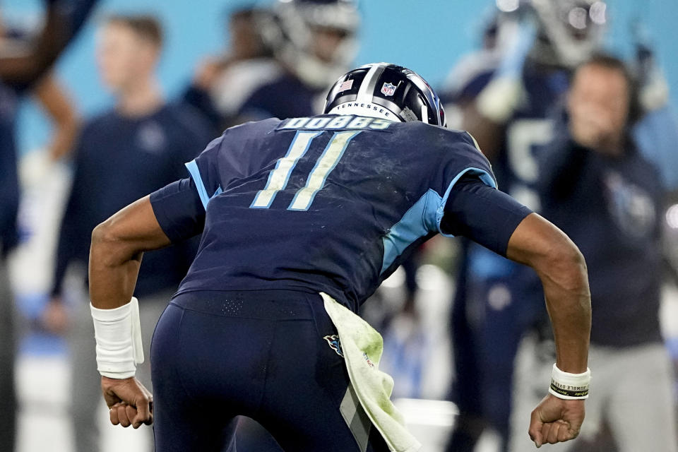 Tennessee Titans quarterback Joshua Dobbs (11) celebrates his first touchdown pass in the NFL during the second half of an NFL football game between the Tennessee Titans and the Dallas Cowboys, Thursday, Dec. 29, 2022, in Nashville, Tenn. (AP Photo/Chris Carlson)