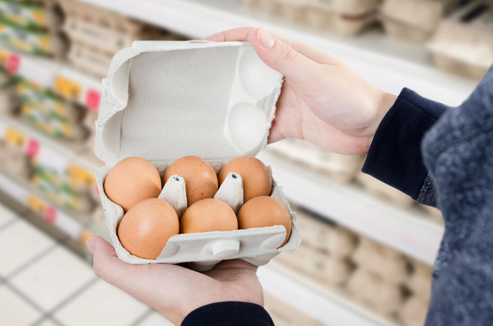 Man buys eggs in the supermarket. Egg store supermarket price expensive grocery shop concept