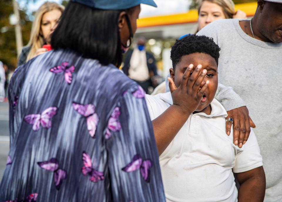 Crowds gather at the intersection of Joy Lane and Airways Boulevard in South Memphis near the scene of a fatal shooting that reportedly killed Memphis rapper Young Dolph on Wednesday afternoon, Nov. 17, 2021, in Memphis, Tenn.