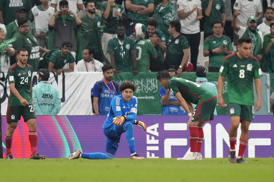 Mexico's goalkeeper Guillermo Ochoa, centre, reacts after Saudi Arabia scored during the World Cup group C soccer match between Saudi Arabia and Mexico, at the Lusail Stadium in Lusail, Qatar, Wednesday, Nov. 30, 2022. (AP Photo/Moises Castillo)