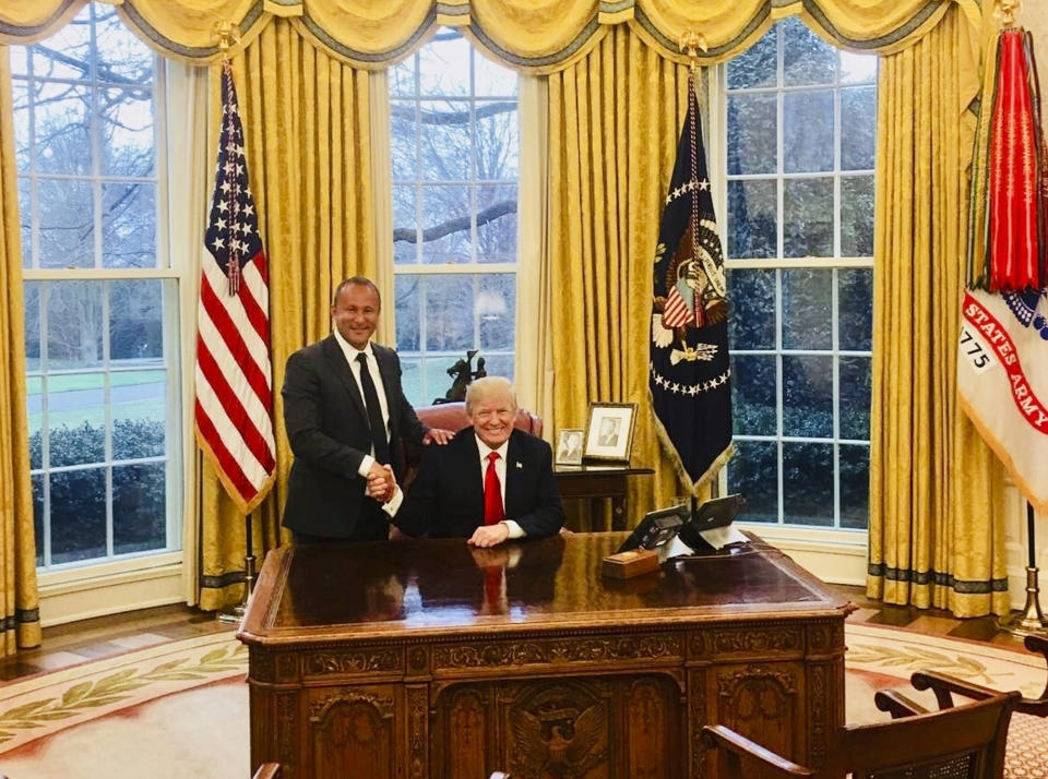 This image from the website of Allied Wallet CEO Ahmad "Andy" Khawaja shows Khawaja posing with President Donald Trump in the Oval Office of the White House in Washington. Khawaja gave more than $4 million to Hillary Clinton's failed presidential campaign and other Democrats, then began extending his largesse to Republicans after a lunch with GOP fundraiser Elliott Broidy two weeks after Trump clinched the presidency. Records obtained by The Associated Press show that Khawaja has helped pornographers, payday loan debt collectors and offshore gambling operations get past the gates of the banking system.(Andy Khawaja via AP)