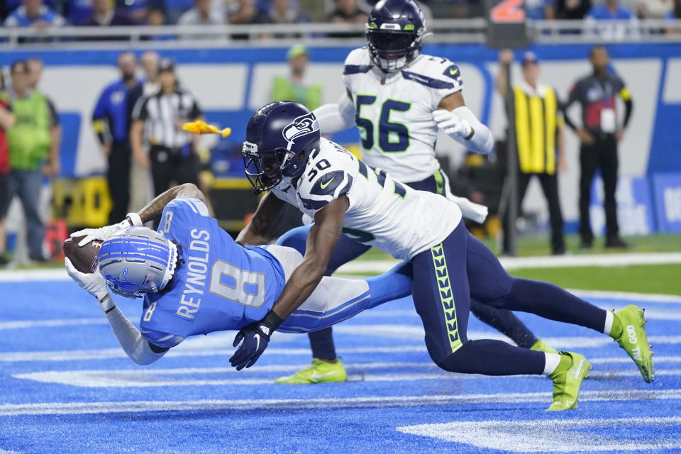 Detroit Lions wide receiver Josh Reynolds (8), defended by Seattle Seahawks cornerback Mike Jackson (30), catches a 3-yard pass for a touchdown during the second half of an NFL football game, Sunday, Oct. 2, 2022, in Detroit. (AP Photo/Paul Sancya)