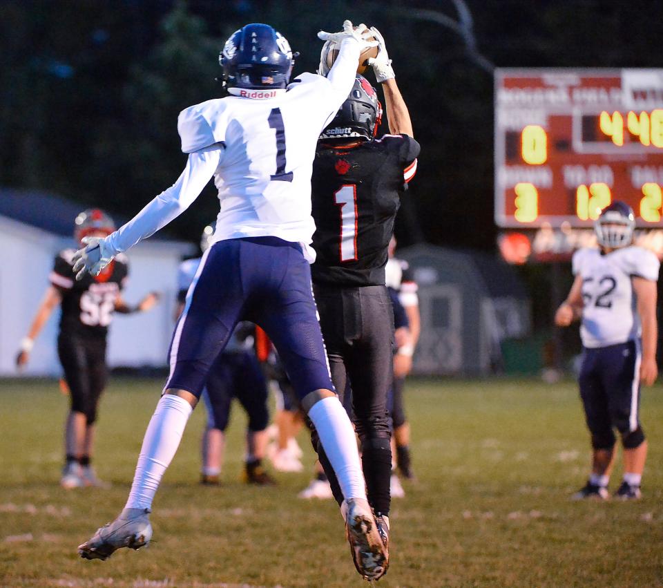 Northwestern defensive back Kolton Sutter, center right, grabs his second interception of the first half, in front of Oil City sophomore Gavin Stephens, left, in Albion on Sept. 23, 2022. Sutter had seven interceptions on the season.