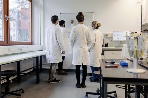 STOCK PHOTO: A group of medical students discussing some work while huddled around a whiteboard at the lab together. (STOCK PHOTO/Getty Images)