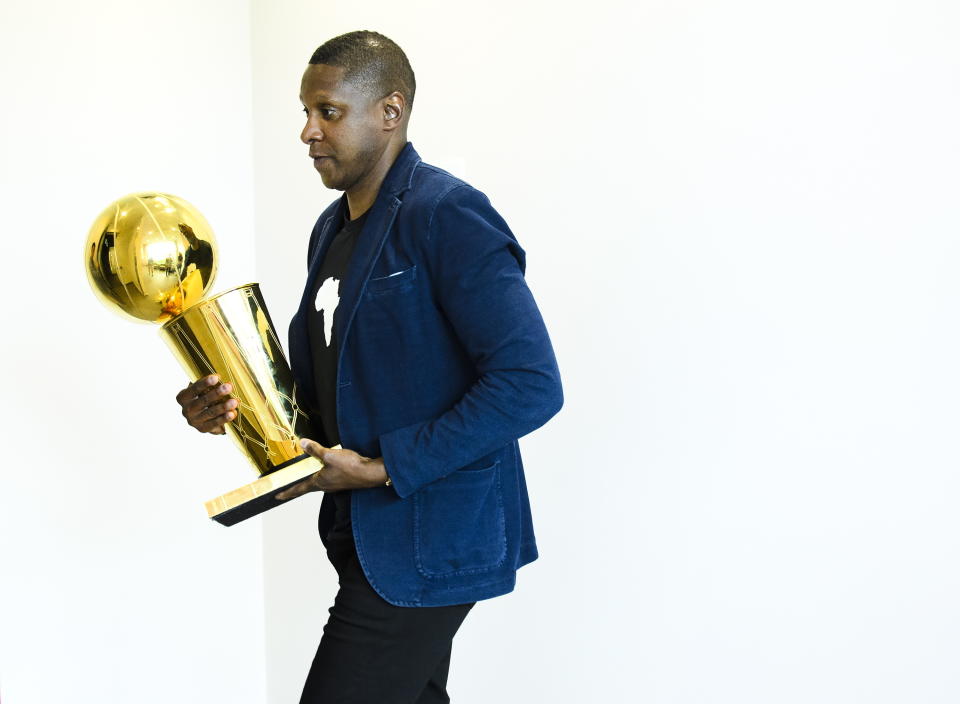 Toronto Raptors NBA basketball team president Masai Ujiri carries the Larry O'Brien Trophy as he leaves an end-of-season press conference in Toronto, Tuesday, June 25, 2019. (Nathan Denette/The Canadian Press via AP)