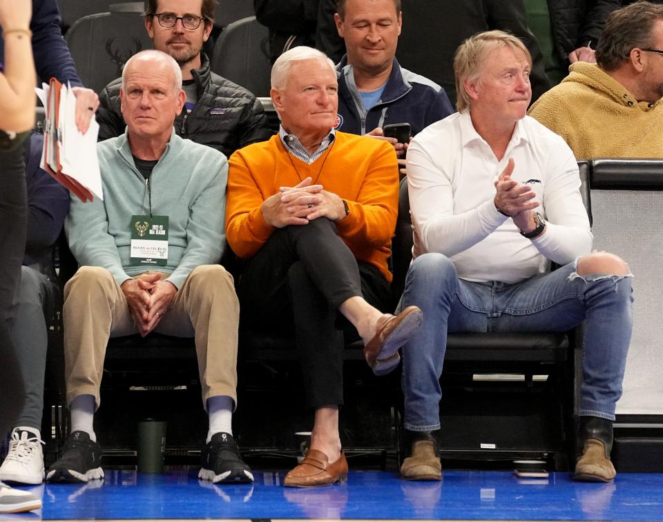 Potential Milwaukee Bucks owner Jimmy Haslam (orange sweater) sits next to Milwaukee Bucks owner Wes Eden, right)  during the first half of their game against the Boston Celtics Thursday, March 30, 2023 at Fiserv Forum in Milwaukee, Wis. On the far left is Charles Slatery.