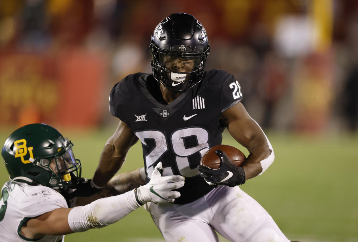 Iowa State running back Breece Hall, right, fends off a tackle attempt by Baylor linebacker Matt Jones during the second half of an NCAA college football game Saturday, Nov. 7, 2020, in Ames, Iowa. Iowa State won 38-31. (AP Photo/Matthew Putney)