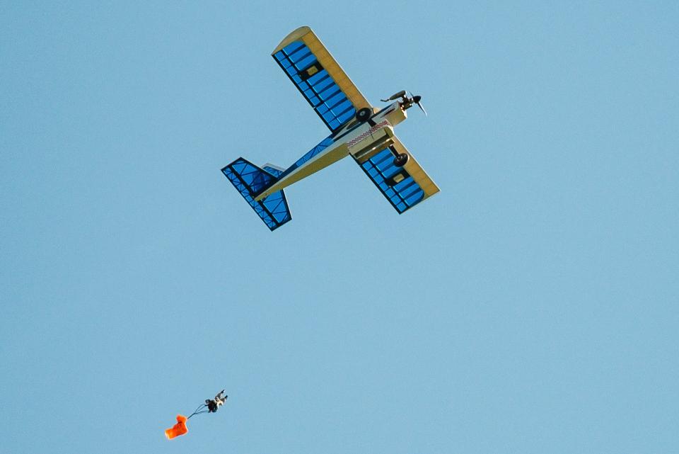 A GI Joe action figure parachutes out of one of Timothy Lohr's 14 aircraft brought in for the annual Academy of Model Aeronautics National Model Aviation Day. He outfitted one of his planes with a special servo-controlled drop box to enable the action figures to parachute to the ground over the club’s field.