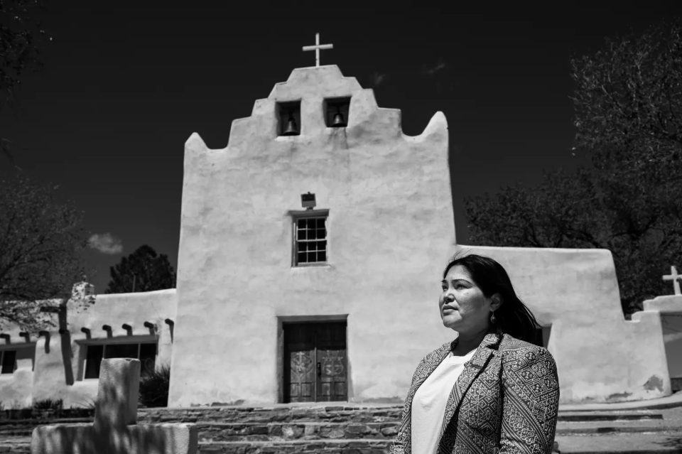 “The separation of Indigenous people has been used as a tool of genocide, a form of violence against our community and our children,” said Angel Charley, executive director of the Coalition to Stop Violence Against Native Women. Charley is pictured here outside the San José de la Laguna Mission Church, in Laguna Pueblo.