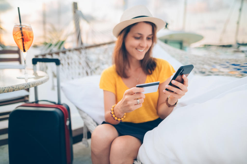 Woman making credit card payments from smartphone