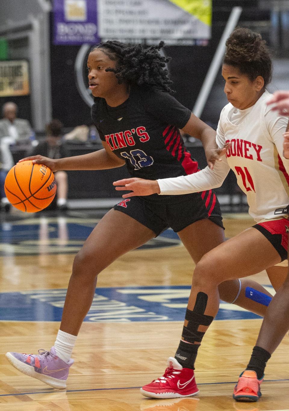 King's Academy's Jade Jones (13) drives up the court against Cardinal Mooney during the first half of their FHSAA Girls 3-A semifinal at The RP Funding Center in Lakeland Wednesday. February 23, 2022.