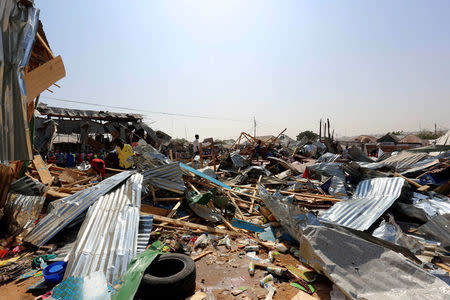 Traders attempt to salvage their goods at the scene of a suicide bomb explosion at the Wadajir market in Madina district of Somalia's capital Mogadishu, February 19, 2017. REUTERS/Feisal Omar