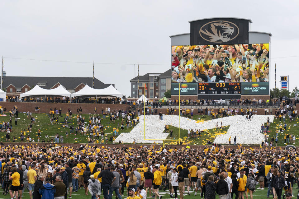 Fans rush the field after Missouri defeated Kansas State 30-27 in an NCAA college football game Saturday, Sept. 16, 2023, in Columbia, Mo. (AP Photo/L.G. Patterson)