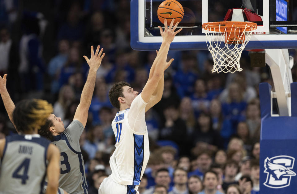 Creighton's Ryan Kalkbrenner, right, shoots against Butler's Boden Kapke during the first half of an NCAA college basketball game Friday, Feb. 2, 2024, in Omaha, Neb. (AP Photo/Rebecca S. Gratz)
