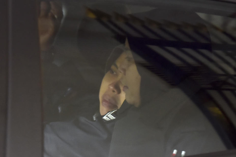 Indonesian Siti Aisyah, left, is escorted by police as she leaves the Court of Appeal after a court hearing in Putrajaya, Malaysia, Thursday, Jan. 24, 2019. Aisyah jointly accused of murdering Kim Jong Nam, the estranged half-brother of North Korea's leader, won an appeal to obtain witness statements given to police as part of her defense. But prosecutors say they will challenge the court's ruling in the nation's top court. (AP Photo/Yam G-Jun)