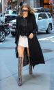 <p>Out in NYC wearing a semi-sheer tee over a mini dress with a black duster jacket and knee-high snakeskin boots. </p>