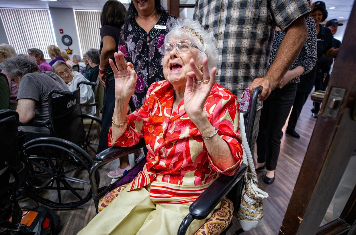 Velma Thompson reacts as she is wheeled into her surprise 105th birthday party Tuesday afternoon at Lake Morton Senior Living in Lakeland. Mayor Bill Mutz made an appearance to read a letter honoring Thompson, the oldest of several centenarians at the facility.