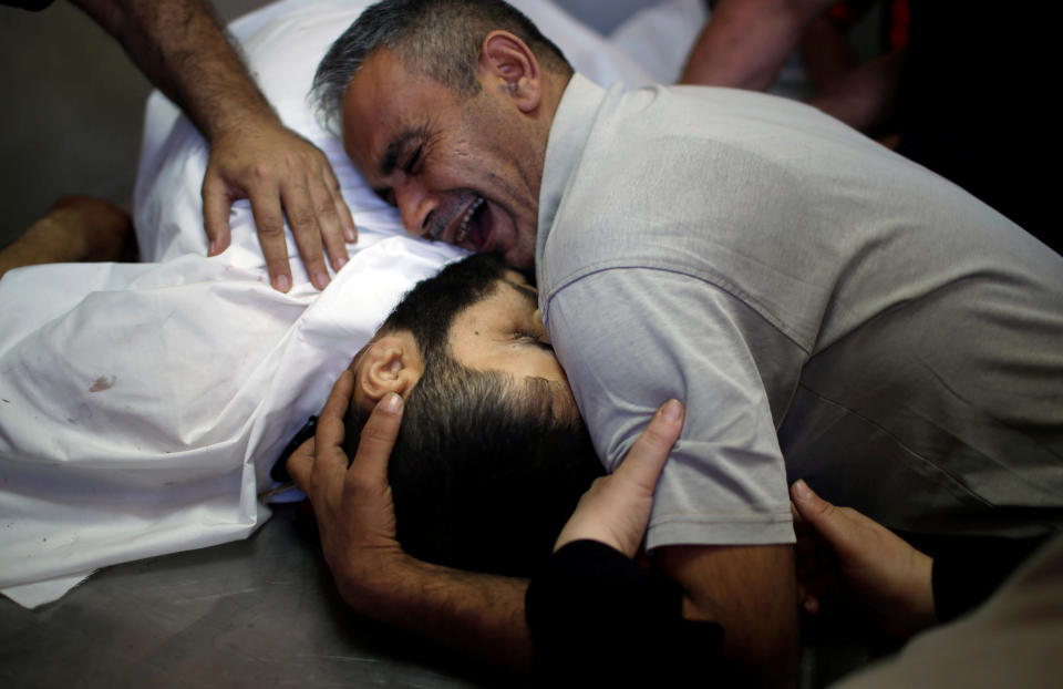 The brother of Palestinian Shaher al-Madhoon, who was killed during a protest at the Israel-Gaza border, reacts over his body at a hospital morgue in the northern Gaza Strip.&nbsp;