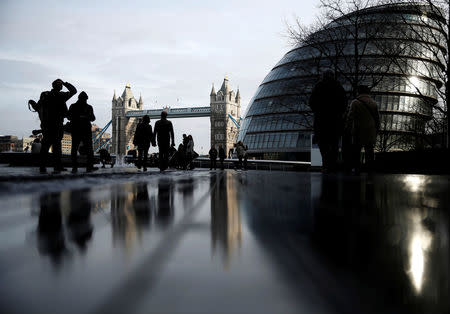 FILE PHOTO: Pedestrians walk near City Hall and Tower Bridge in London, Britain January 24, 2016. REUTERS/Neil Hall/File Photo