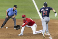 Texas Rangers first baseman Nate Lowe, center, catches a throw from catcher Jose Trevino (not shown) to throw out Minnesota Twins' Alex Kirilloff (19) during the sixth inning of a baseball game in Arlington, Texas, Friday, June 18, 2021. (AP Photo/Andy Jacobsohn)