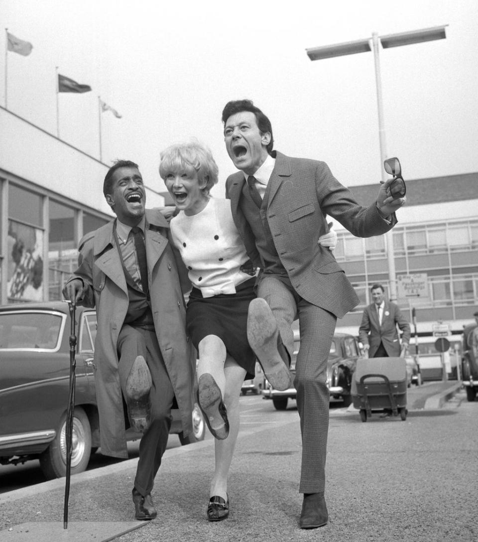 (l-r) Sammy Davis Jr joins Lionel Blair and his wife Joyce at London Airport (PA) (PA Archive)