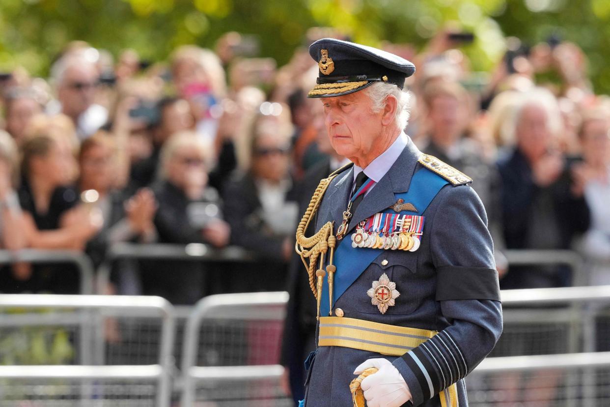 Britain's King Charles III follows the coffin of Queen Elizabeth II, adorned with a Royal Standard and the Imperial State Crown and pulled by a Gun Carriage of The King's Troop Royal Horse Artillery, during a procession from Buckingham Palace to the Palace of Westminster, in London on September 14, 2022. - Queen Elizabeth II will lie in state in Westminster Hall inside the Palace of Westminster, from Wednesday until a few hours before her funeral on Monday, with huge queues expected to file past her coffin to pay their respects. (Photo by Martin Meissner / POOL / AFP) (Photo by MARTIN MEISSNER/POOL/AFP via Getty Images)