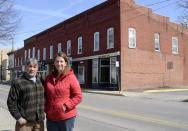 Michael and Lurie Portanova stand in front of their commercial property in Jersey Shore, Pa. on Sunday March 23, 2014. The couple bought the buildings with the intention of restoring their historical details and opening a cafe and canoe rental business. Thanks to a congressional rollback, their insurance rate will reset, but will immediately start climbing again, year after year. Within five years, the bill will be more than $8,700. Within a decade, it will be more than $26,000. "There's no way we can afford that. Just no way," said Michael Portanova. "We'd have to let it go back to the bank and walk away from it." (AP Photo/Ralph Wilson)