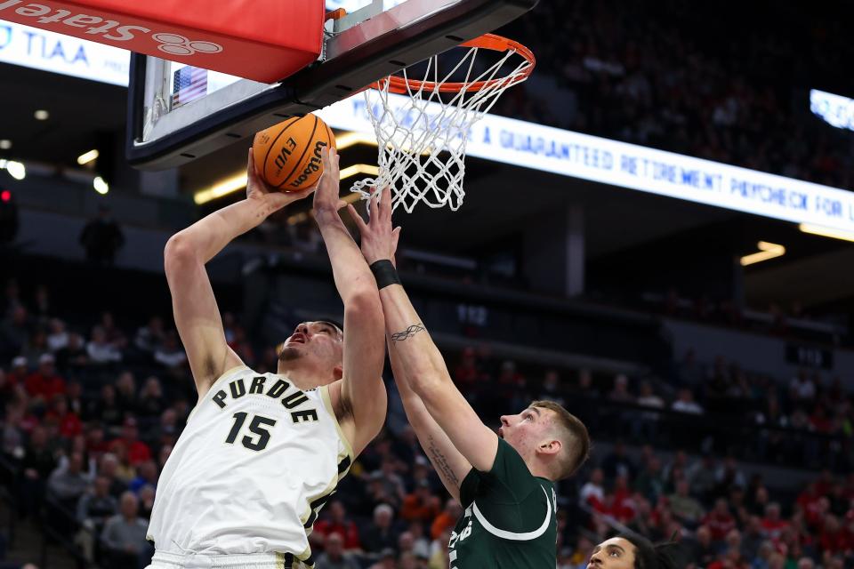 Mar 15, 2024; Minneapolis, MN, USA; Purdue Boilermakers center Zach Edey (15) shoots as Michigan State Spartans center Carson Cooper (15) defends during the first half at Target Center. Mandatory Credit: Matt Krohn-USA TODAY Sports