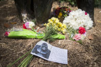 <p>A sympathy card rests at the feet of a gorilla statue at the Cincinnati Zoo & Botanical Garden. <em>(AP Photo/John Minchillo)</em> </p>