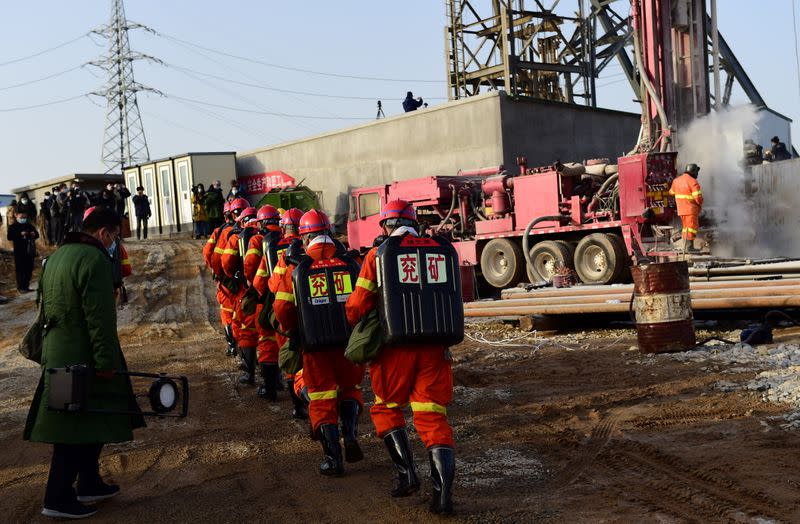 Rescuers are seen at the site where workers were trapped underground after an explosion at the gold mine under construction, in Qixia