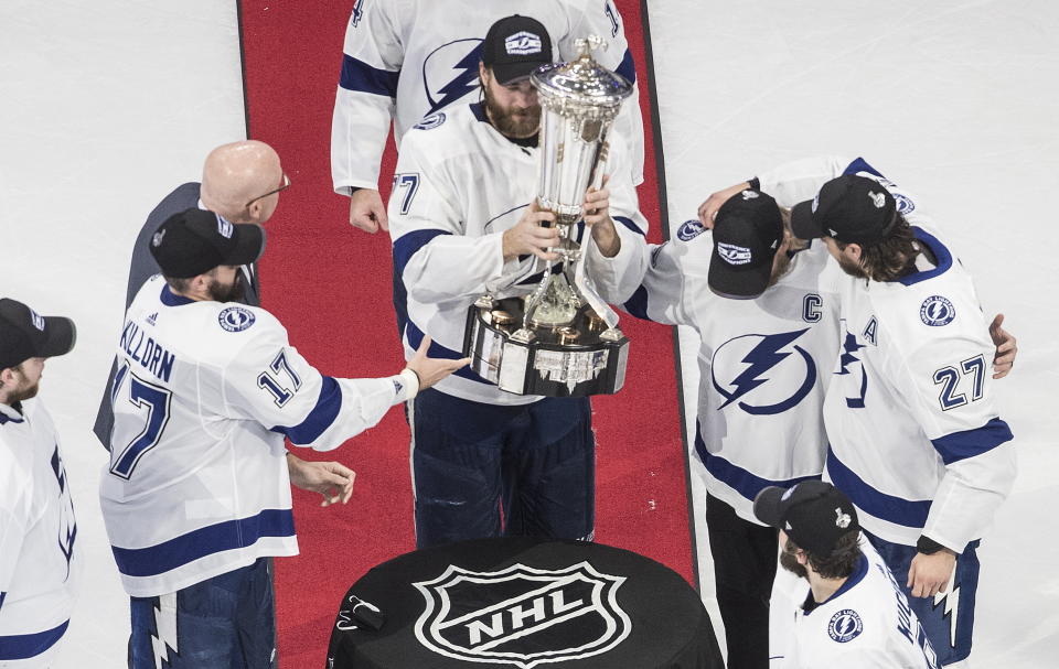 Tampa Bay Lightning's Victor Hedman (77) picks up the Prince of Wales trophy after the Lightning defeated the New York Islanders in overtime in Game 6 of the NHL hockey Eastern Conference final, Thursday, Sept. 17, 2020, in Edmonton, Alberta. (Jason Franson/The Canadian Press via AP)