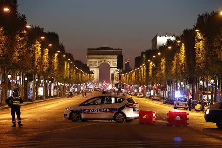 Police secure the Champs Elysee Avenue after one policeman was killed and another wounded in a shooting incident in Paris, France, April 20, 2017. REUTERS/Christian Hartmann