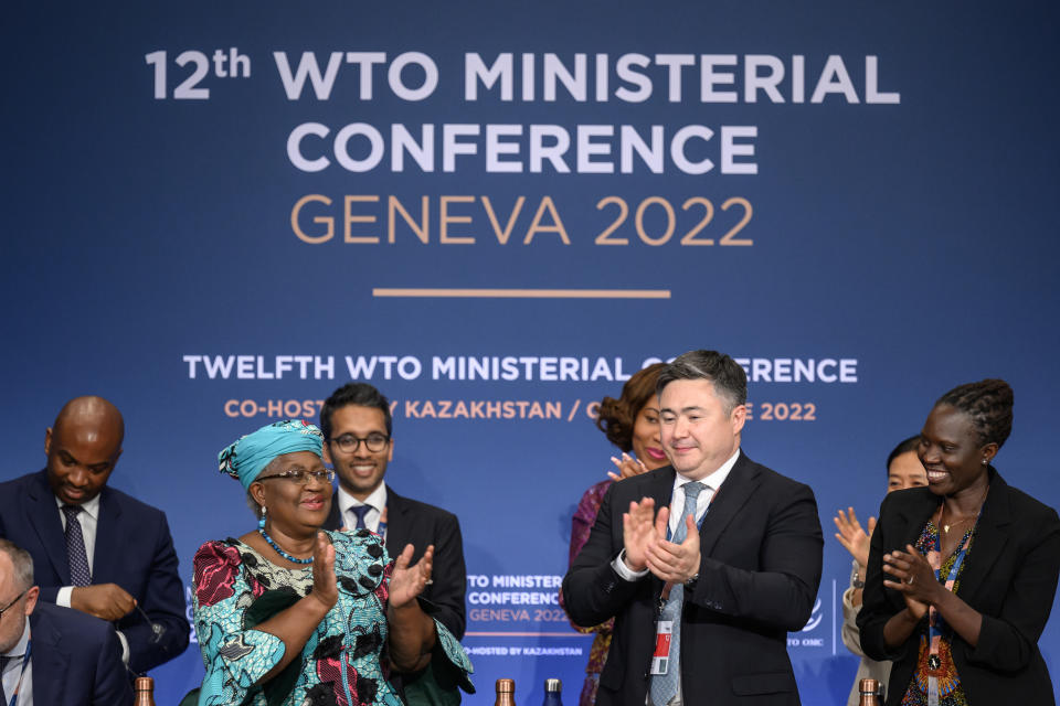 World Trade Organization Director-General Ngozi Okonjo-Iweala, front left, applause next to conference chair Timur Suleimenov, second right, after a closing session of a World Trade Organization Ministerial Conference at the WTO headquarters in Geneva early Friday, June 17, 2022. (Fabrice Coffrini/Pool Photo/Keystone via AP)