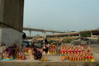 NEW DELHI, INDIA - 2020/10/14: Idol makers preparing idols for the upcoming festival of 'Navratri' under a flyover in Mayur Vihar. During 9 days people in northern India worship 9 avatar or forms of Durga with utmost devotion. This month is usually an opportunity to earn for both idol sellers and makers. (Photo by Pradeep Gaur/SOPA Images/LightRocket via Getty Images)