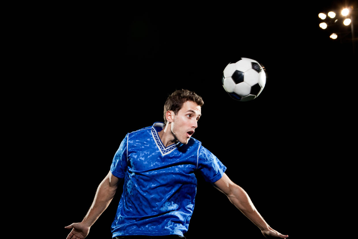 Repeatedly 'heading' a football is increasingly being linked to dementia. (Posed by a model, Getty Images)