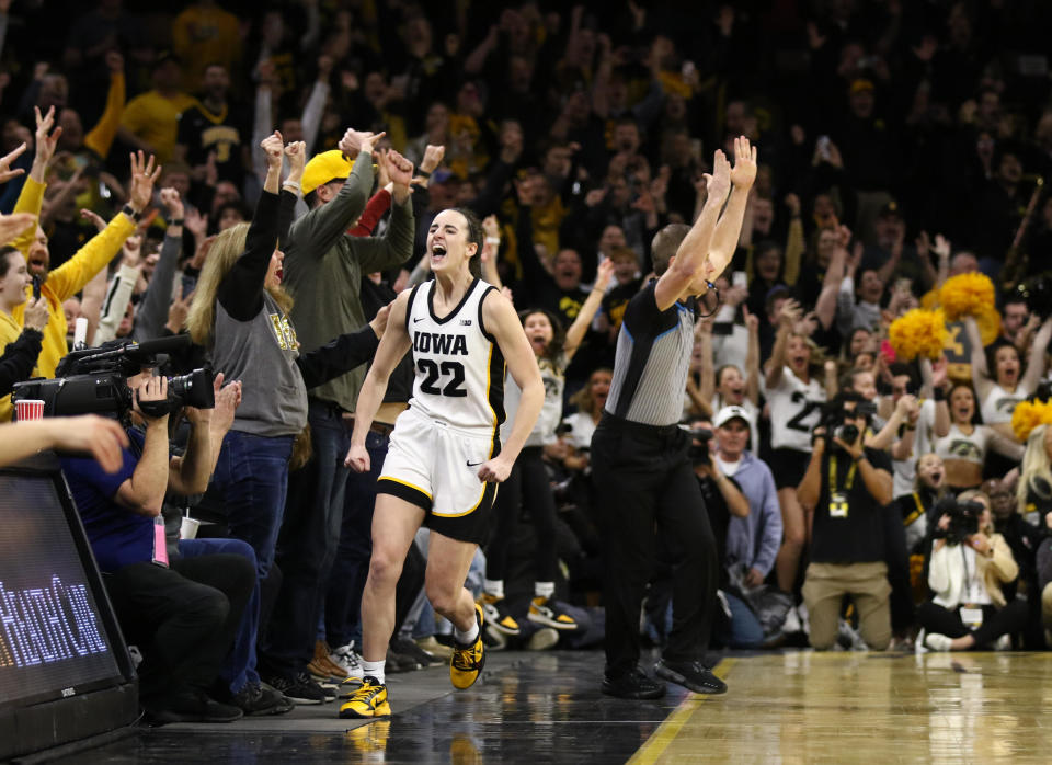 Caitlin Clark of the Iowa Hawkeyes celebrates after breaking the NCAA women's all-time scoring record during the first half against the Michigan Wolverines  at Carver-Hawkeye Arena on February 15, 2024, in Iowa City, Iowa. / Credit: Getty Images