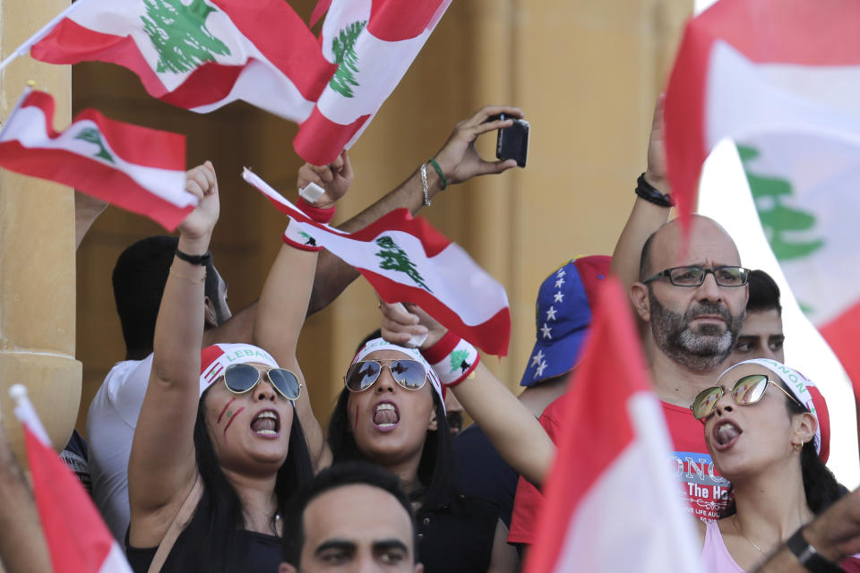 Anti-government protesters shout slogans against the Lebanese government during a protest in Beirut, Lebanon, Monday, Oct. 21, 2019. Lebanon's Cabinet approved Monday sweeping reforms that it hopes will appease thousands of people who have been protesting for five days, calling on Prime Minister Saad Hariri's government to resign. (AP Photo/Hassan Ammar)