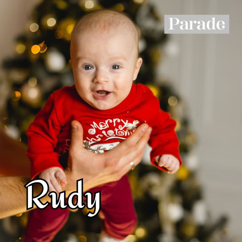 A baby boy smiling in front of a Christmas tree. <p>Unsplash</p>