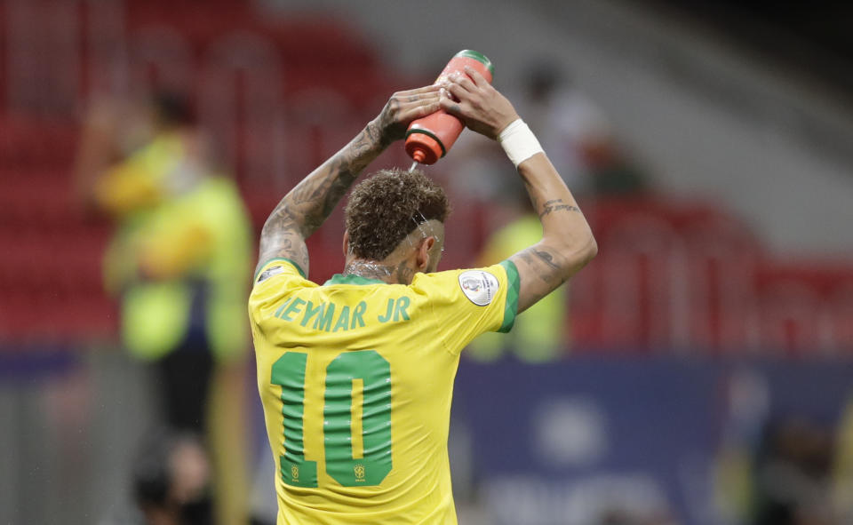 Brazil's Neymar refreshes himself during a Copa America soccer match against Venezuela at the National Stadium in Brasilia, Brazil, Sunday, June 13, 2021. (AP Photo/Eraldo Peres)