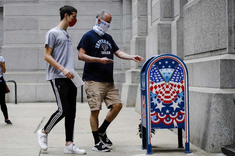 Benjamin Graff (center) and son Jacob Graff, 19, drop off their mail-in ballots for the Pennsylvania primary election in Philadelphia on June 2, 2020. (Photo: MATT ROURKE/ASSOCIATED PRESS)