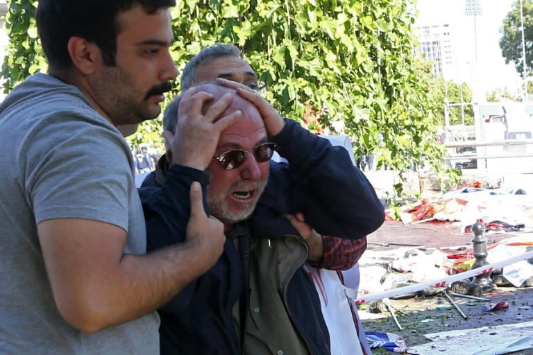 A man is helped after bombs were set off at a peace rally in Ankara on October 10, 2015