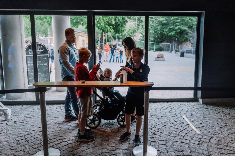 Visitors use sanitizer before entering the Vasa Museum in Stockholm on July 15, 2020 on the day of its reopening amid the new coronavirus pandemic.  / Credit: STINA STJERNKVIST/TT News Agency/AFP/Getty
