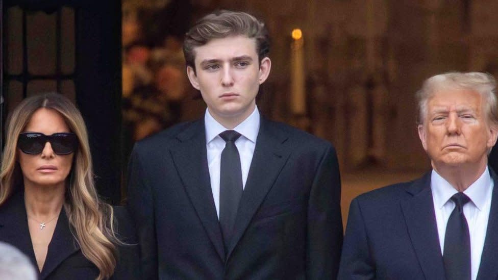 Barron Trump stands alongside his mother Melania and father Donald