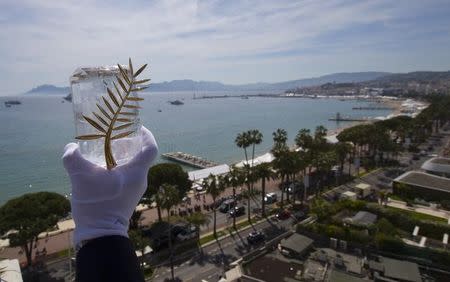 A Chopard representative displays the Palme d'Or, the highest prize awarded to competing films, during an interview before the start of the 68th Cannes Film Festival in Cannes, southern France, May 12, 2015. REUTERS/Yves Herman