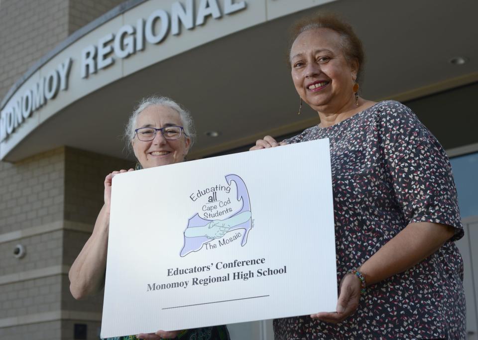 Karen Boujoukos, left, and Angelina Chilaka, stand on Friday outside Monomoy Regional High School in Harwich, with a poster about "Educating all Cape Cod Children: Celebrating the Mosaic Continues," a free anti-racism educators conference set for July 11 at the school.