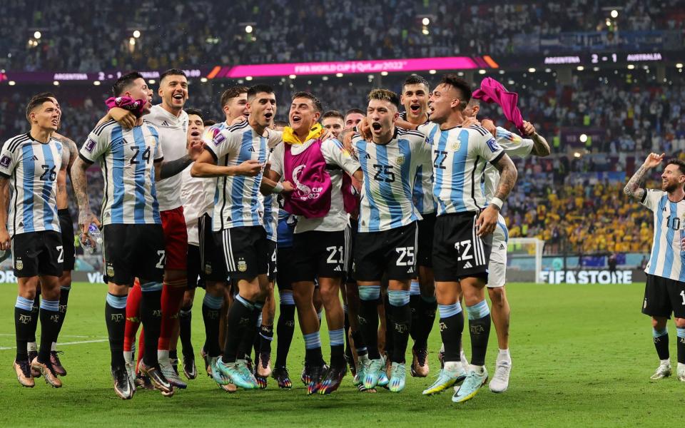 Players of Argentina celebrate after winning the FIFA World Cup 2022 round of 16 soccer match between Argentina and Australia at Ahmad bin Ali Stadium - Shutterstock