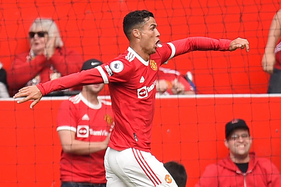 <p>Manchester United's Portuguese striker Cristiano Ronaldo celebrates after scoring the opening goal of the English Premier League football match between Manchester United and Newcastle at Old Trafford in Manchester, north west England, on September 11, 2021.</p>
