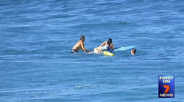 The lifeguards had to take the woman further out and down the beach before they could bring her back into shore. Source: 7 News